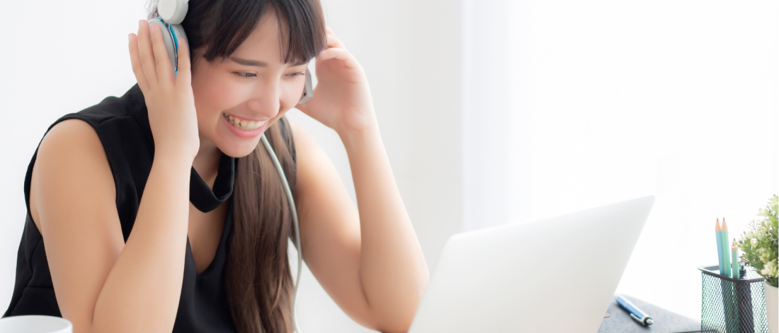 Woman with headphones and laptop