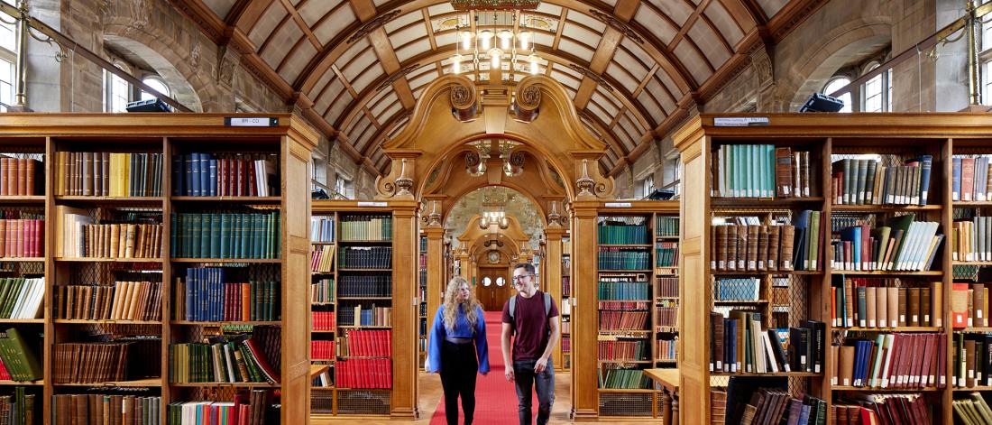 Two students walking through Shankland Library