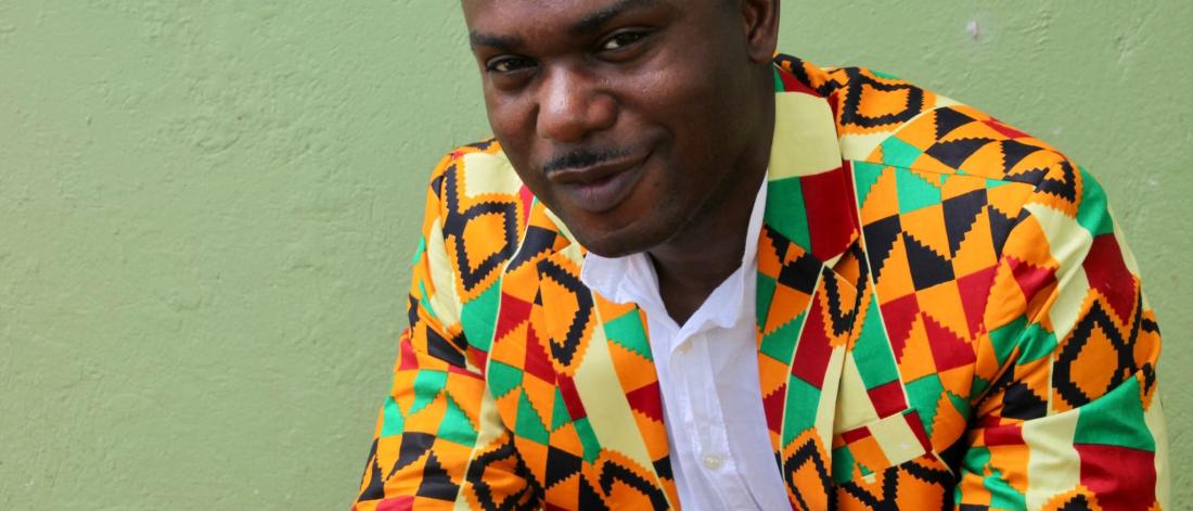 A smiling person in a bright jacket.