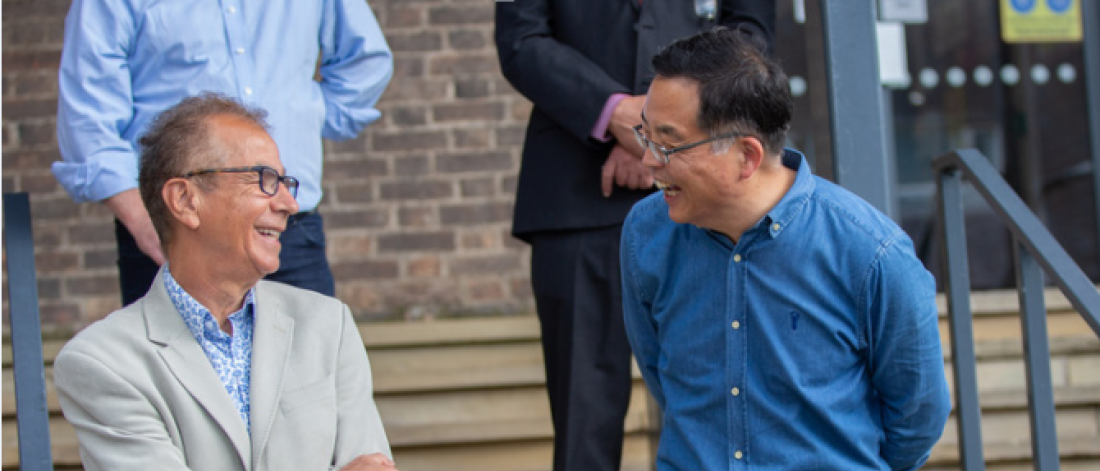 two men on steps laughing