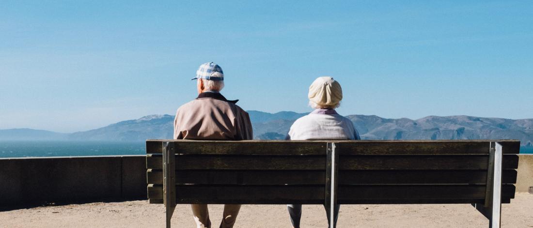 twp people sit on a bench seen from behind