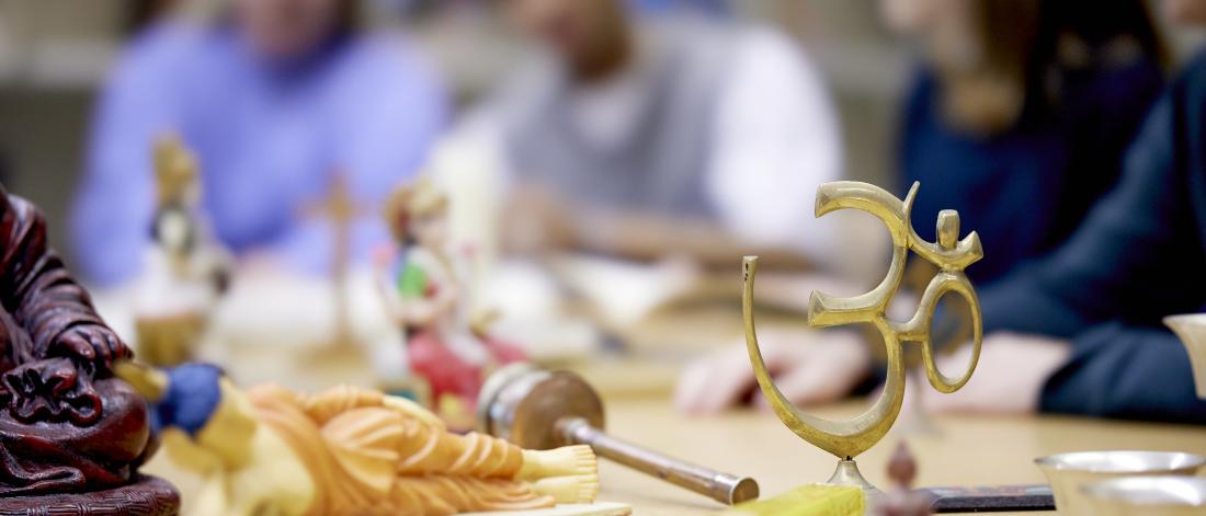 Religious models on table with students looking at them 