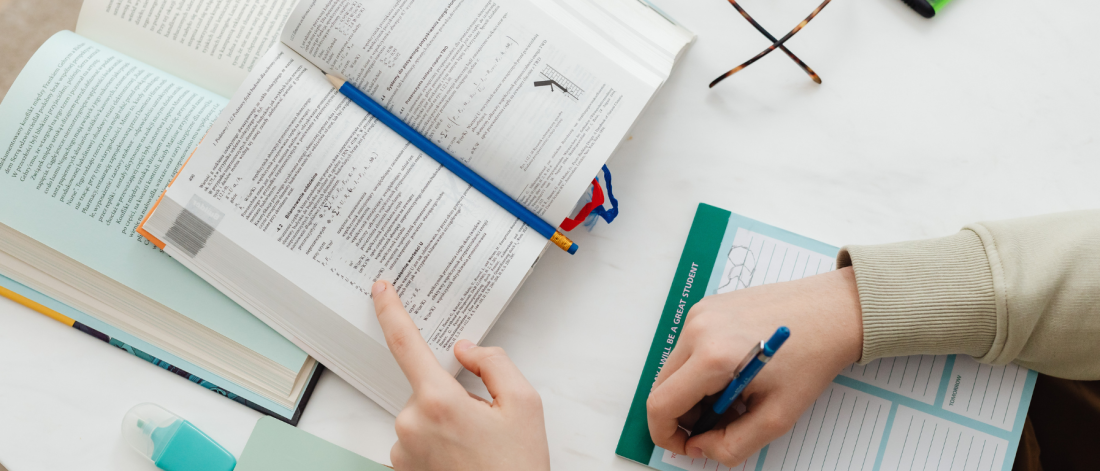 Person with books, glasses and calculator