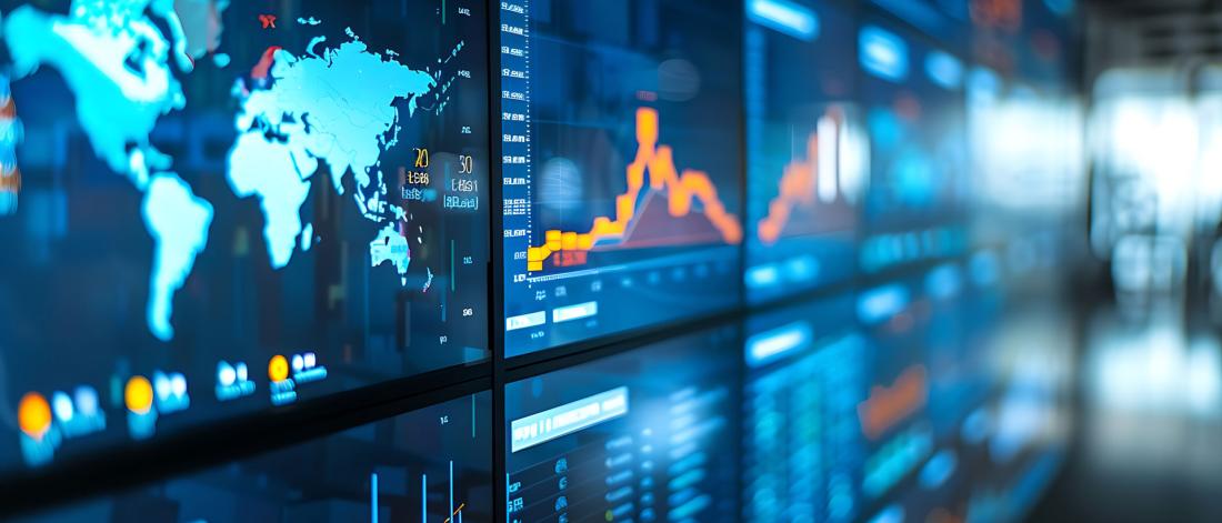 Economic data displayed on a bank of screens