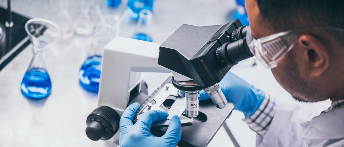 Medical Scientist using a Microscope