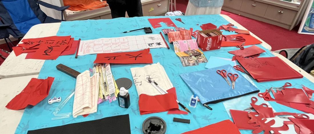 Table with coloured paper and cuttings
