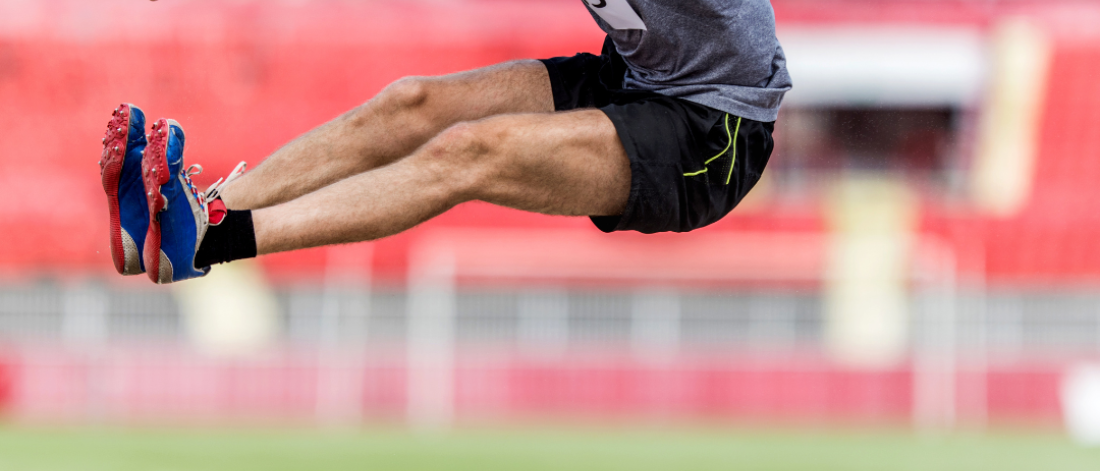 Man mid landing doing a long jump