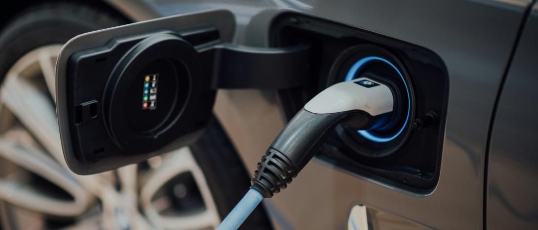electric car charging with focus on the plug