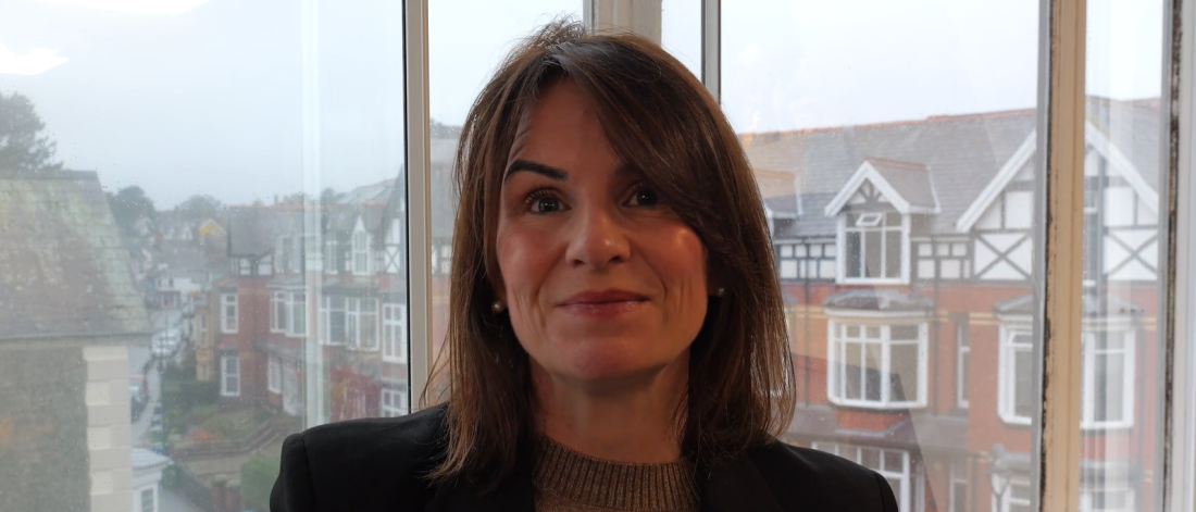 An image of Dr Sara Parry smiling to camera with Bangor city in the background.