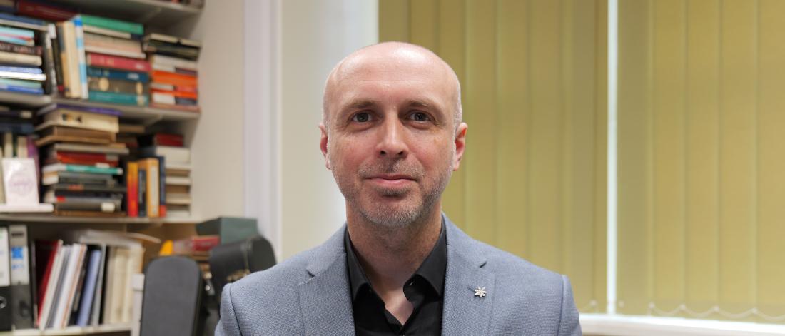 a headshot of John Cunningham, head of arts