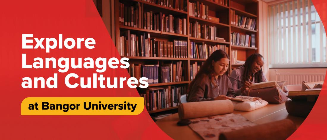 Two students sitting at a table in the university archive, looking through books, with shelves of books behind them. A shield graphic overlays the image with the text ‘Explore Languages and Cultures at Bangor University.'