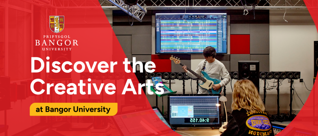 Two students using equipment in a music studio at Bangor University.