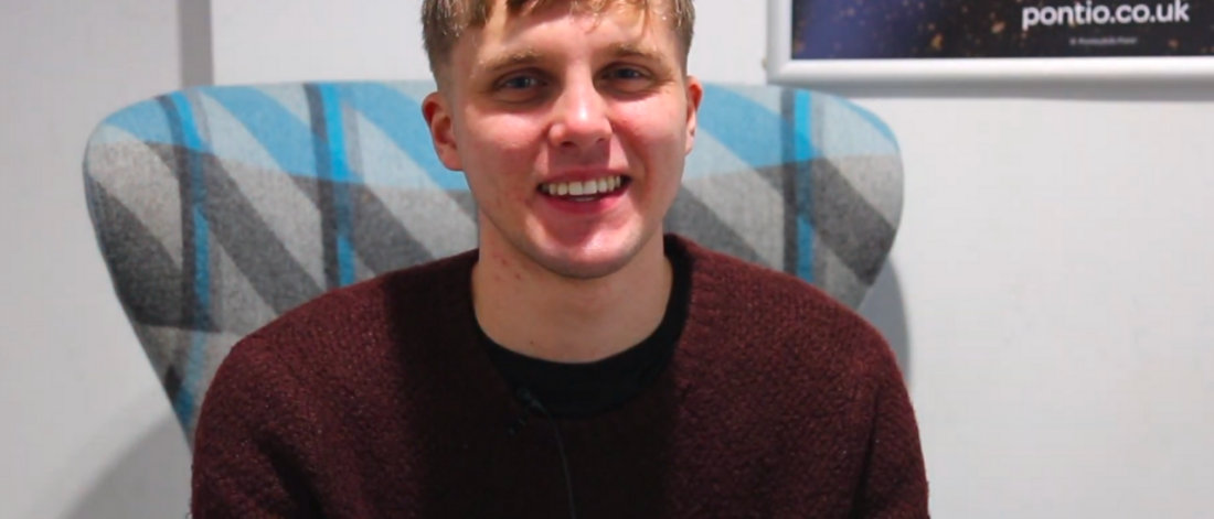 Student George smiling at the camera