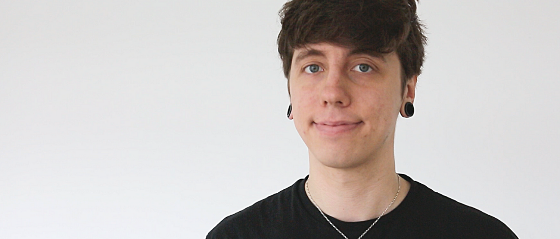 Portrait image of Callum Rhind smiling at the camera.