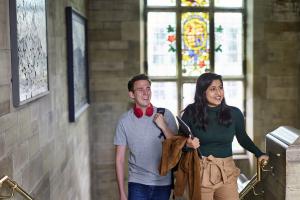 Two students walking up the steps in the Main Arts building