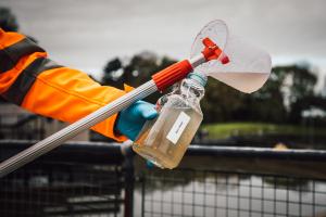 A member of staff tests waste water at a sewage plant