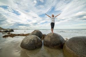 Woman standing on a rock at the beach