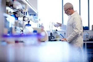 Male wearing a white coat in a Bangor University lab