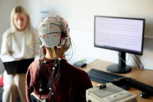 A person is fitted with an electrodes cap in the ERP lab in Bangor University