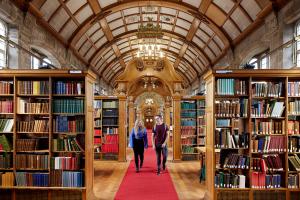 Two students walking through Shankland Library