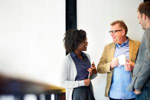 a picture of three people discussing 