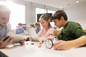 Group of young children learning at a desk