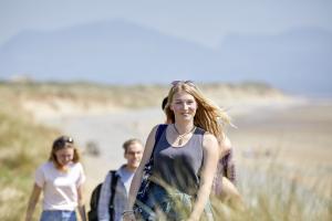 Image of students at the beach smiling