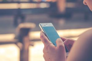Image of person unsing a mobile phone to shop online