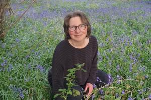 Rebecca Crane in a field of bluebells