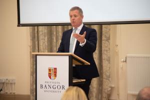 Person standing at lectern 