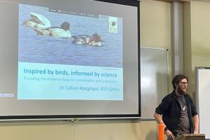 Dr Callum McGregor standing in seminar room