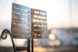 An Award which looks like writing on pages, wrought in metal