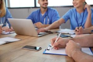 medical professionals sitting around table 