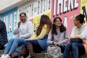 Students sitting on the steps outside Pontio