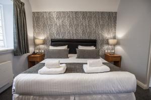 Inside of a double bedroom white and grey linen, white and grey interior decor 