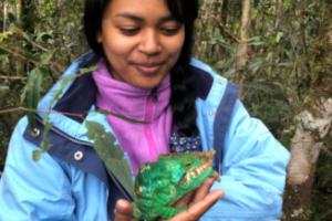 Miary Raselimanana yn gafael mewn cameleon