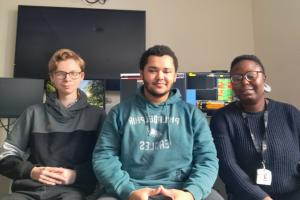 Three Bangor Business School Students smiling to camera 