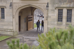 students walking under arch