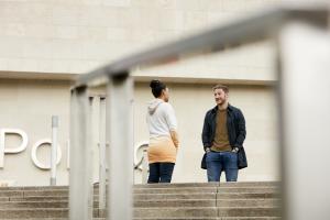 Two students chatting outside Pontio 