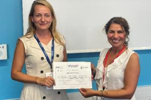 Two women holding a certificate 