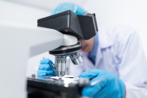 Person working with a microscope in a lab