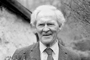Black and white picture of RS Thomas standing outside