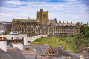 Main University Building with rooftops in foreground