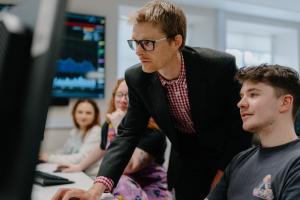 lecturer teaching students in computer lab