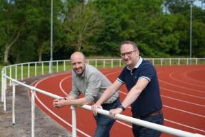 Two people standing on a races course