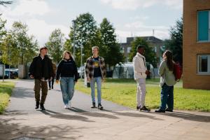 A group of students walking outside at Ffriddoedd village