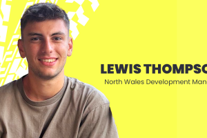 A professional head and shoulder shot of Lewis Thompson on a yellow backgroun with his name and job title, North Wales development manager beside him 