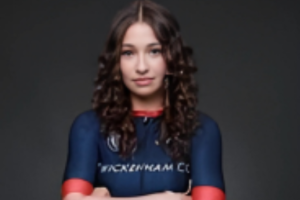 Hannah Price, student, wearing a navy cycling professional top, folding her arms and looking to the camera. 
