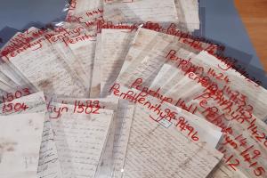 Lots of old letters laid out on a table