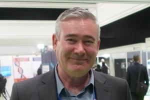 Head shot of Campbell Skinner smiling wearing smart jacket and suit